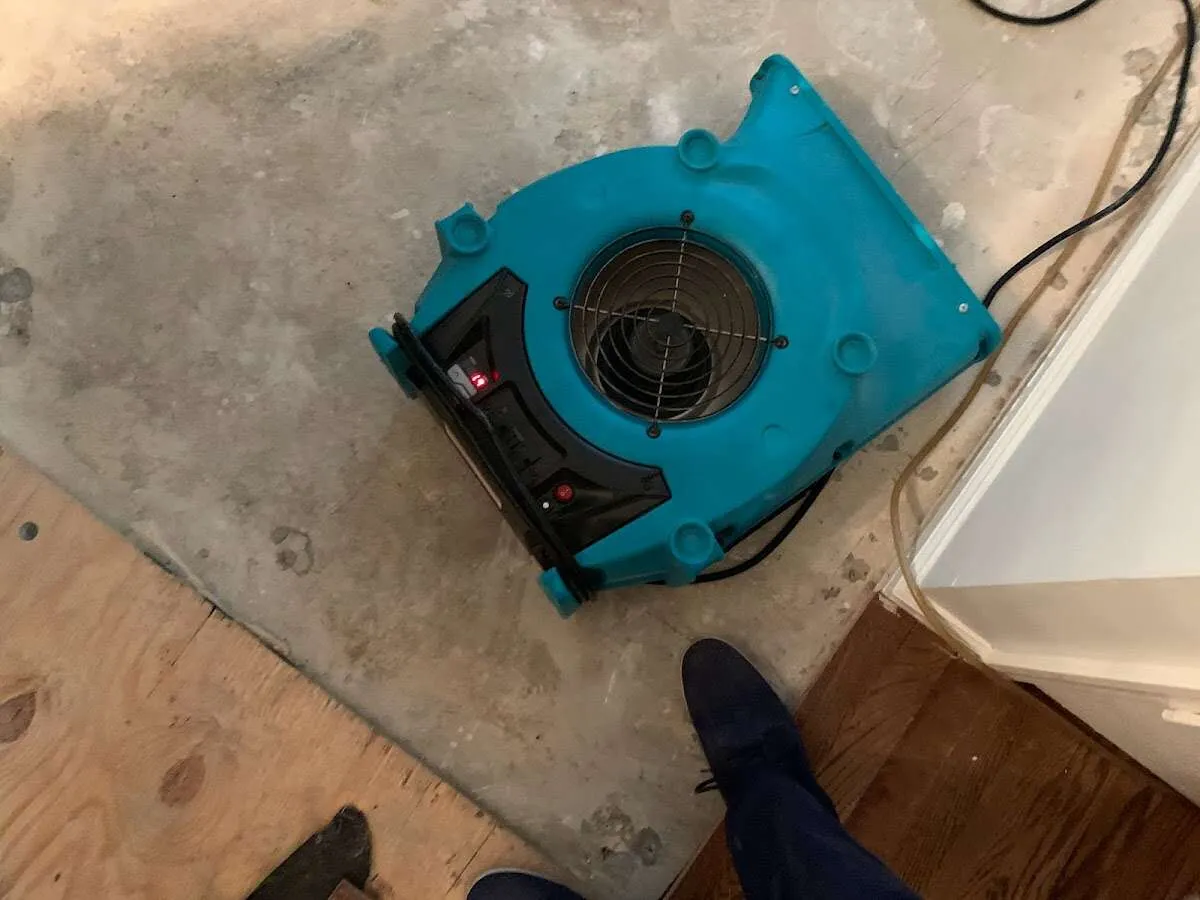 Air mover drying subfloor during Commercial Water Damage Restoration in Columbia City
